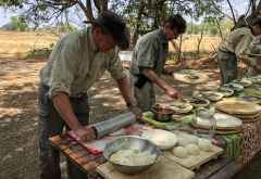 Marco (links) rollt den Teig für die Pizza im Busch &copy; Foto: Outback Africa